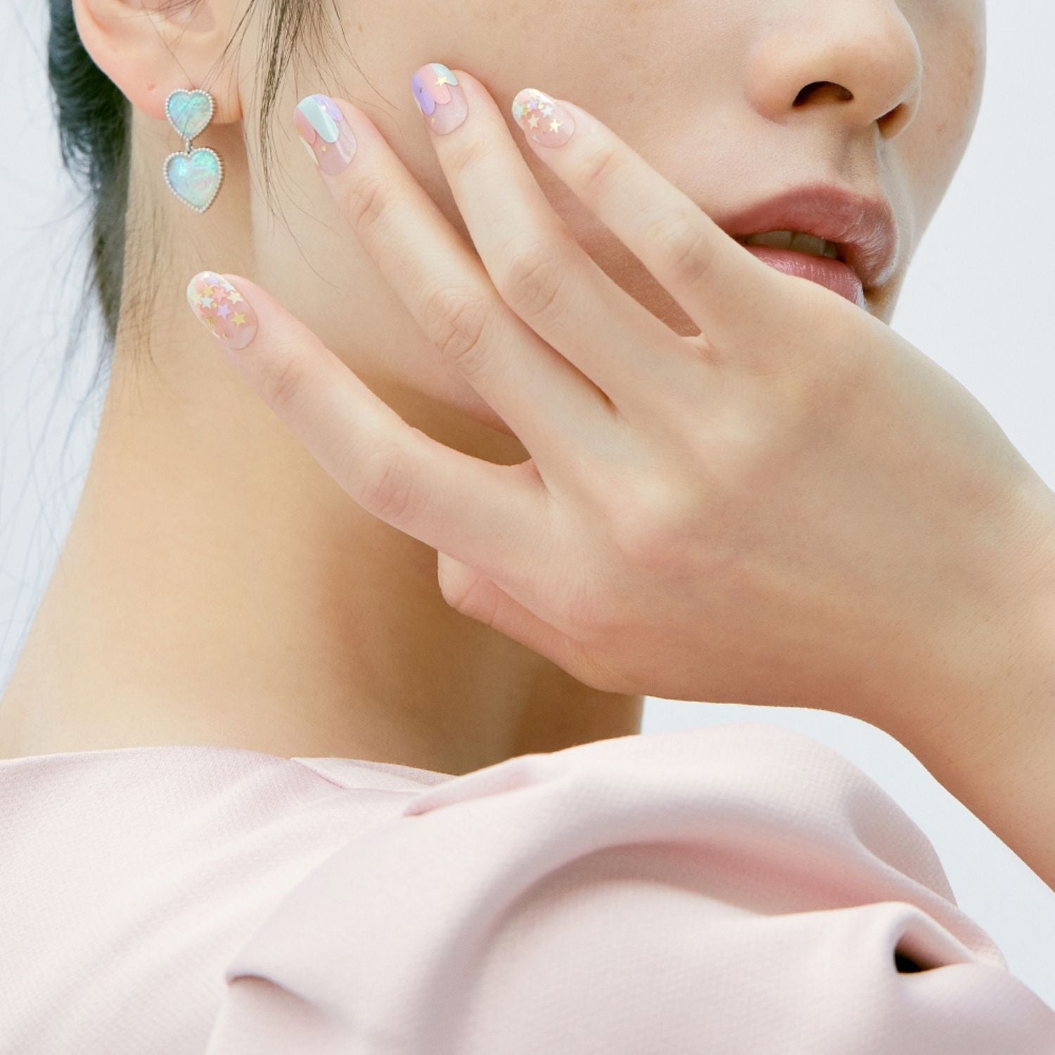 Semi-cured gel nail set by Ohora in N Merry.Go.Round, featuring colorful, round-shaped nail designs on a neutral background.