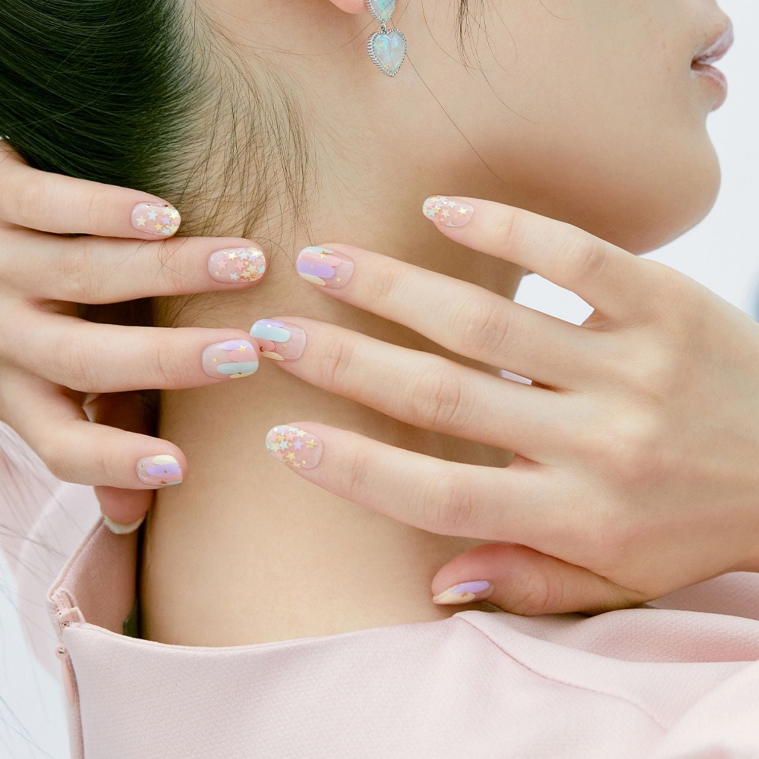 Semi-cured gel nail in N Merry.Go.Round by Ohora, showcasing a glossy, colorful nail design with intricate details.