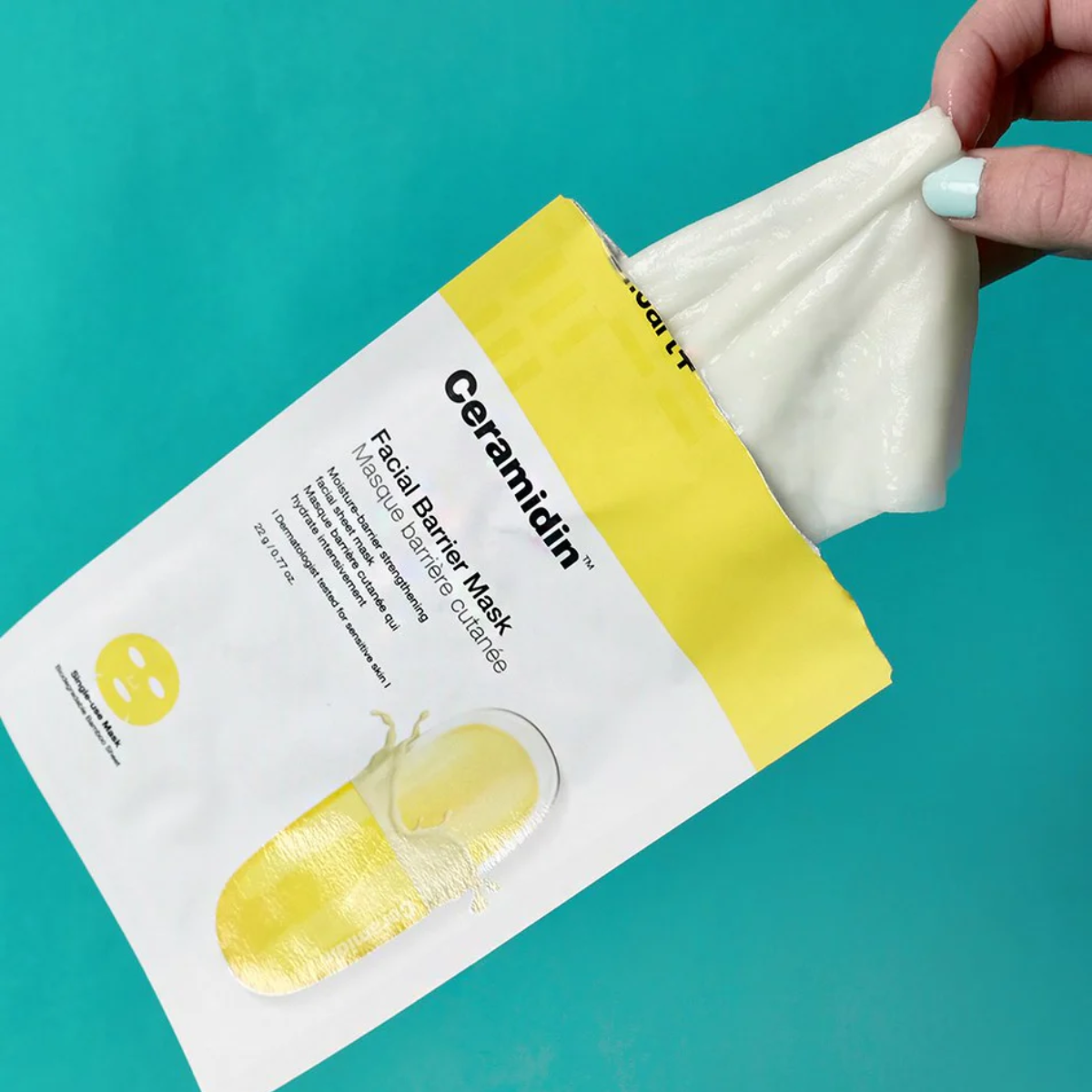 Dr. Jart+ Ceramidin skin barrier moisturizing sheet mask lying flat, with packaging visible, designed to hydrate and strengthen skin.