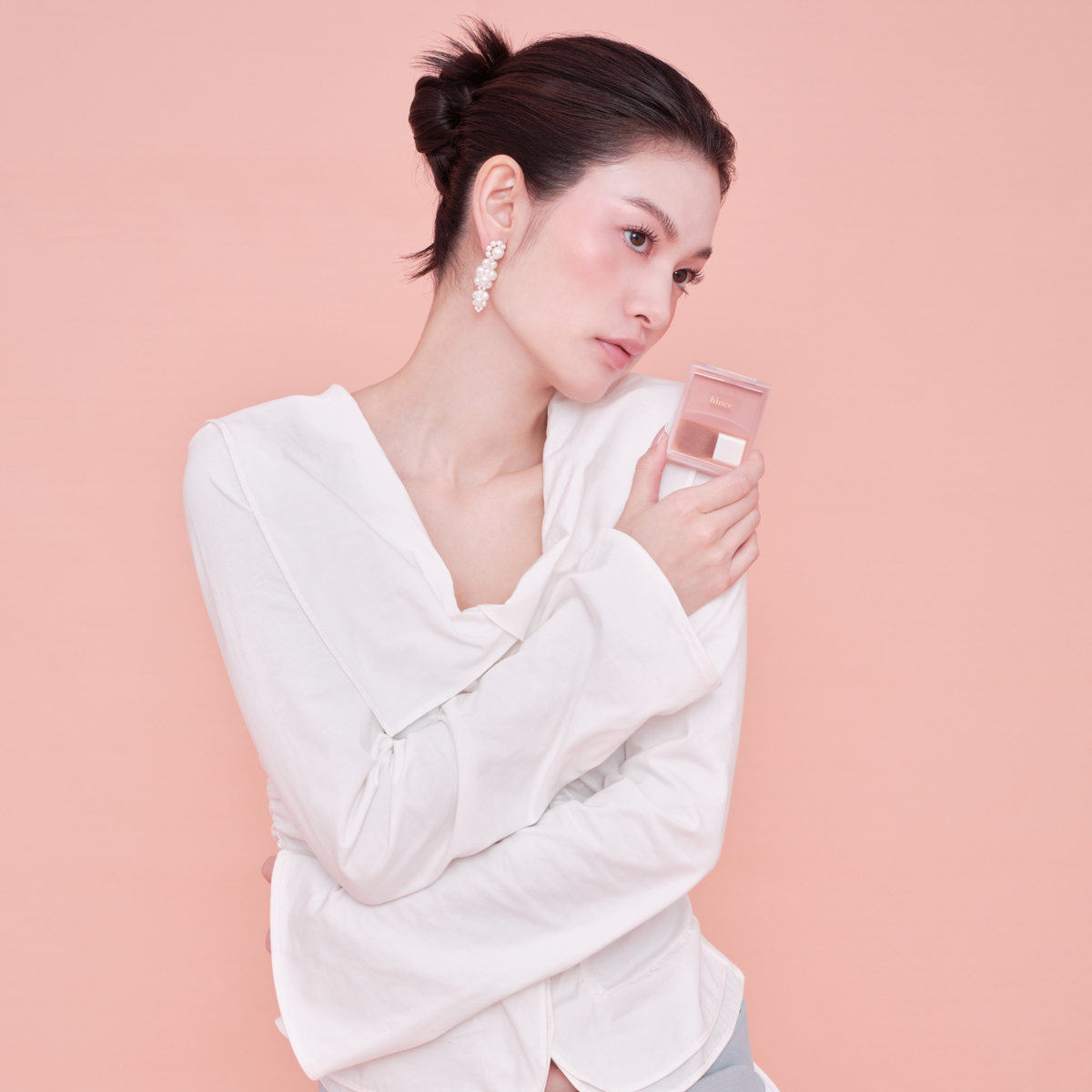 Hince Hug Layer Cheek Blush in a soft pink shade, showing the blush compact open with blush powder visible inside.