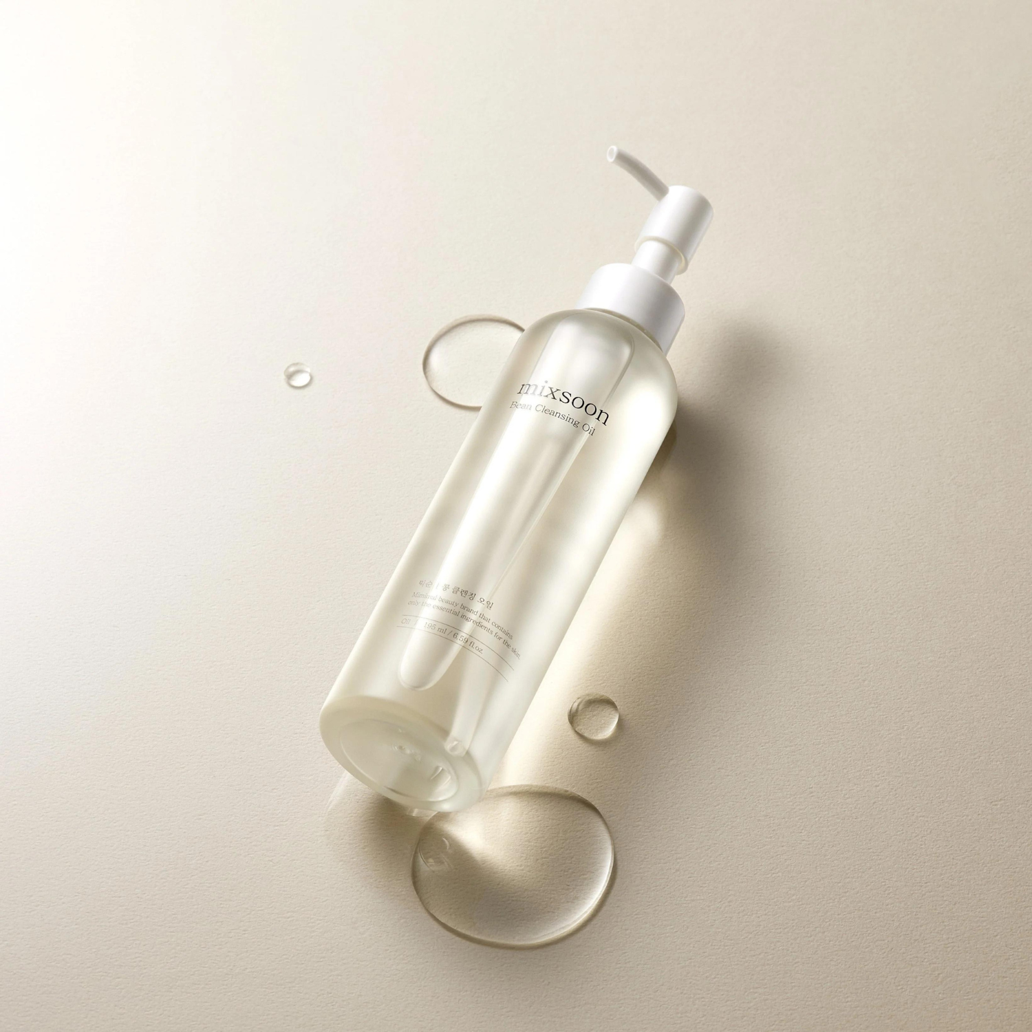 Mixsoon Bean Cleansing Oil 195ml for oil and balm cleansing, shown in a clear bottle with a white pump dispenser.