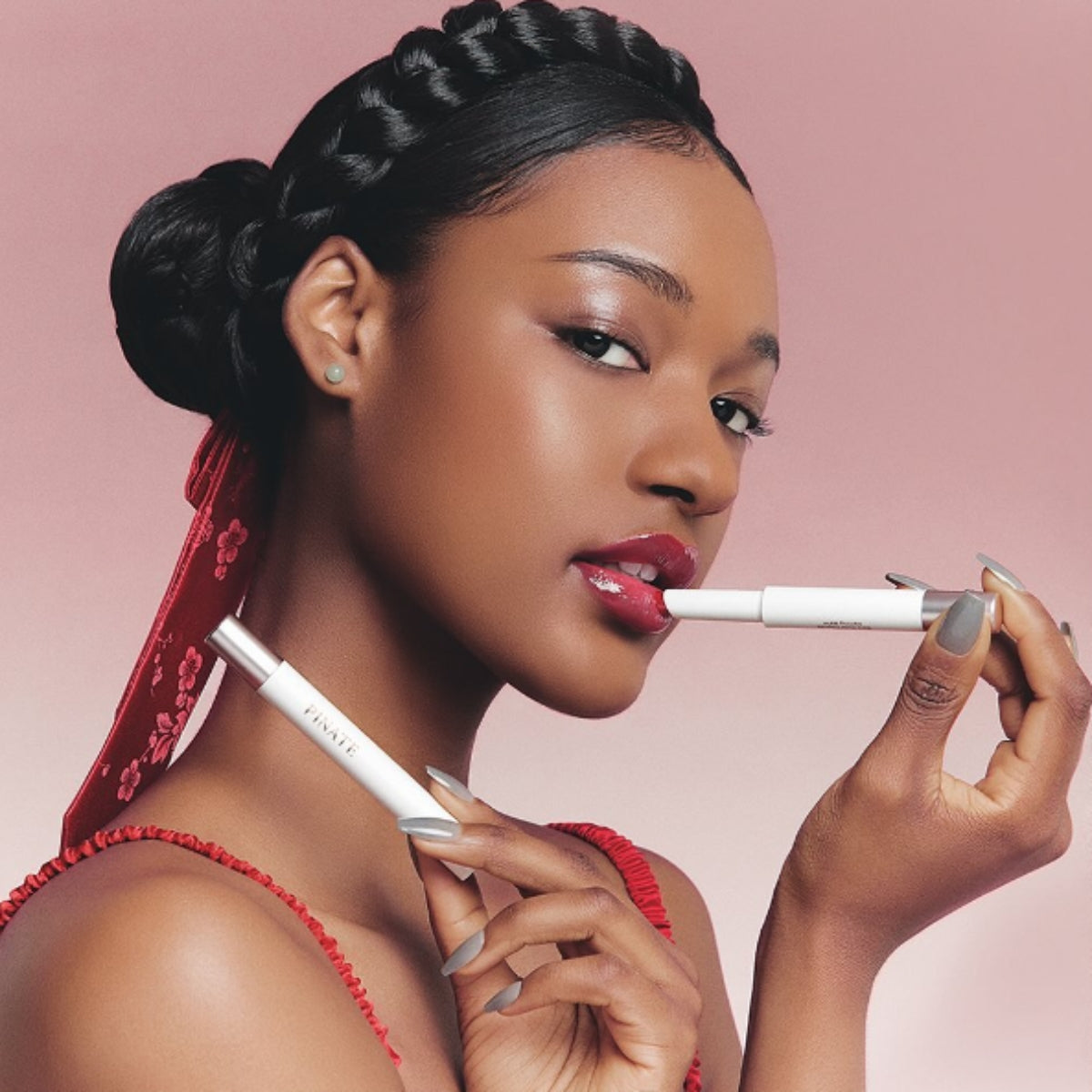 Pinate Bare Glow Peptide Melting Balm lipstick in a sleek tube, ready to add a natural glow to lips.