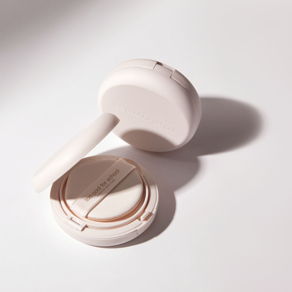 Too Cool For School Fixing Nude Cushion foundation with refill, featuring a compact cushion applicator and soft beige tone.