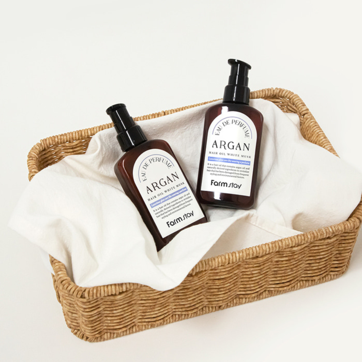 Farmstay Eau De Perfume Argan Hair Oil with White Musk, 100ml bottle showing elegant packaging and applicator for nourishing hair treatment.