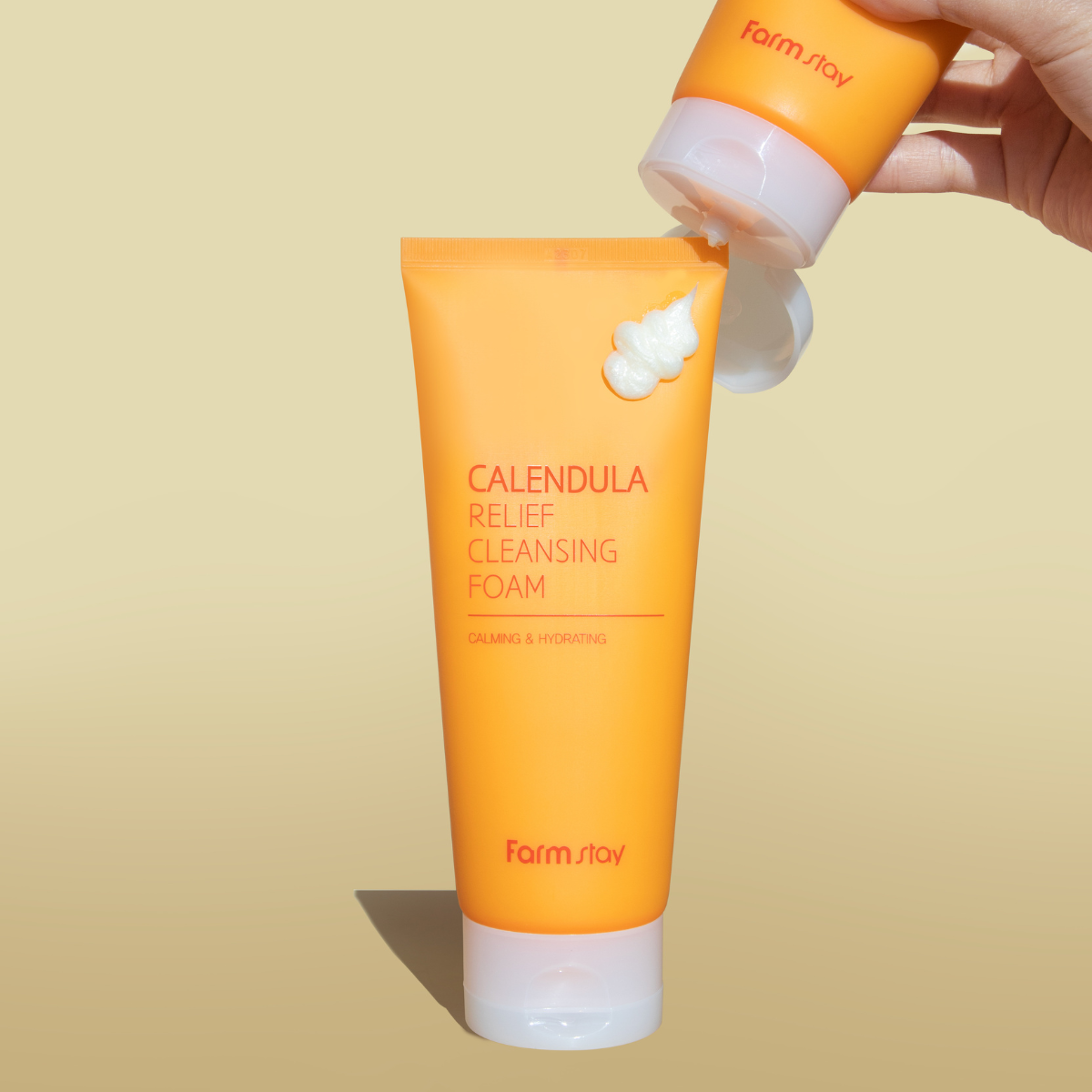 Farmstay Calendula Relief Cleansing Foam in a 180ml tube, showcasing its gel and foam cleanser texture and calming packaging.