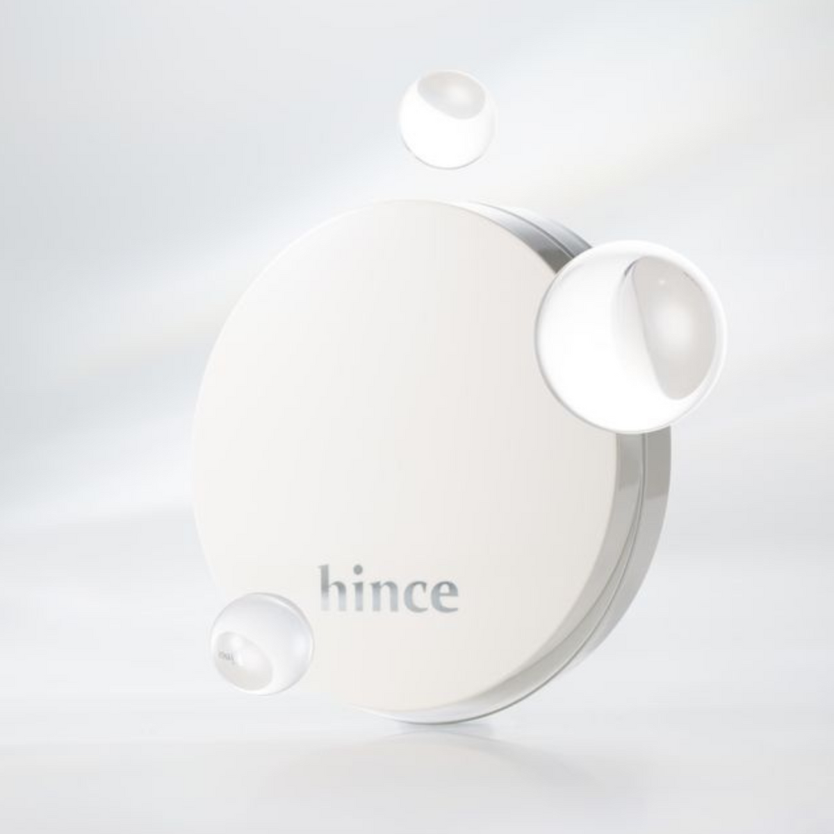 Hince Nu Glow White Cushion foundation in a compact with a mirror, highlighting its sleek white design and applicator sponge.