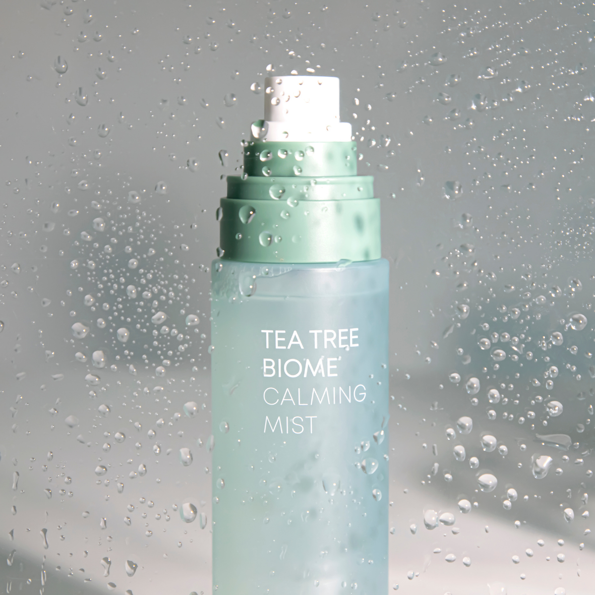 Farmstay Tea Tree Biome Calming Mist 120ml, a facial mist with tea tree extract in a clear spray bottle.
