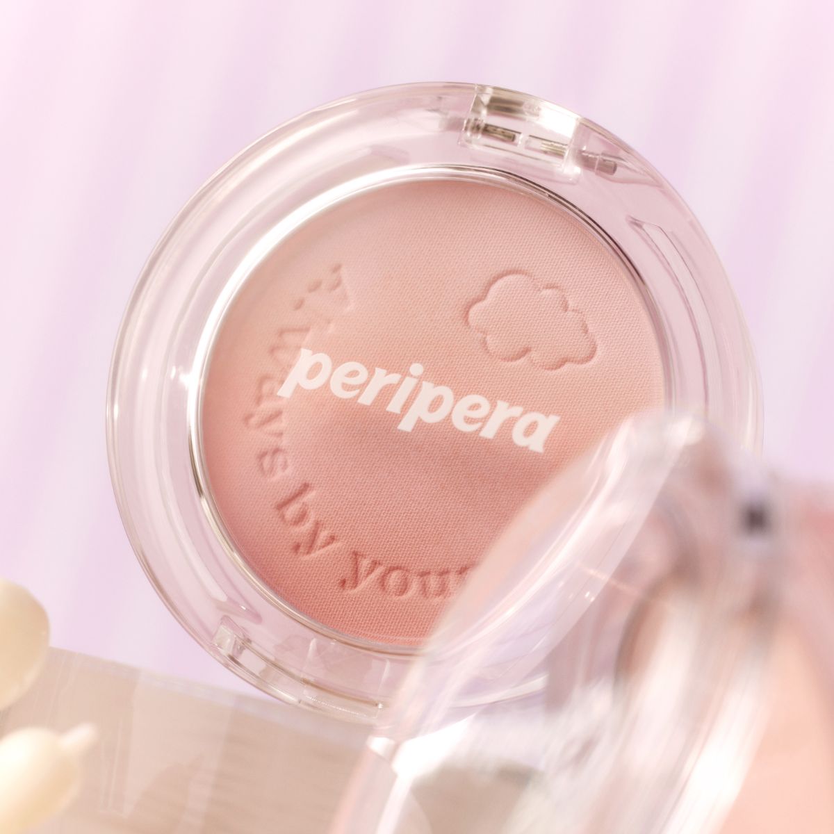 Peripera Pure Blushed Custom Cheek blush in soft pink shade, displayed on a makeup palette with a natural finish