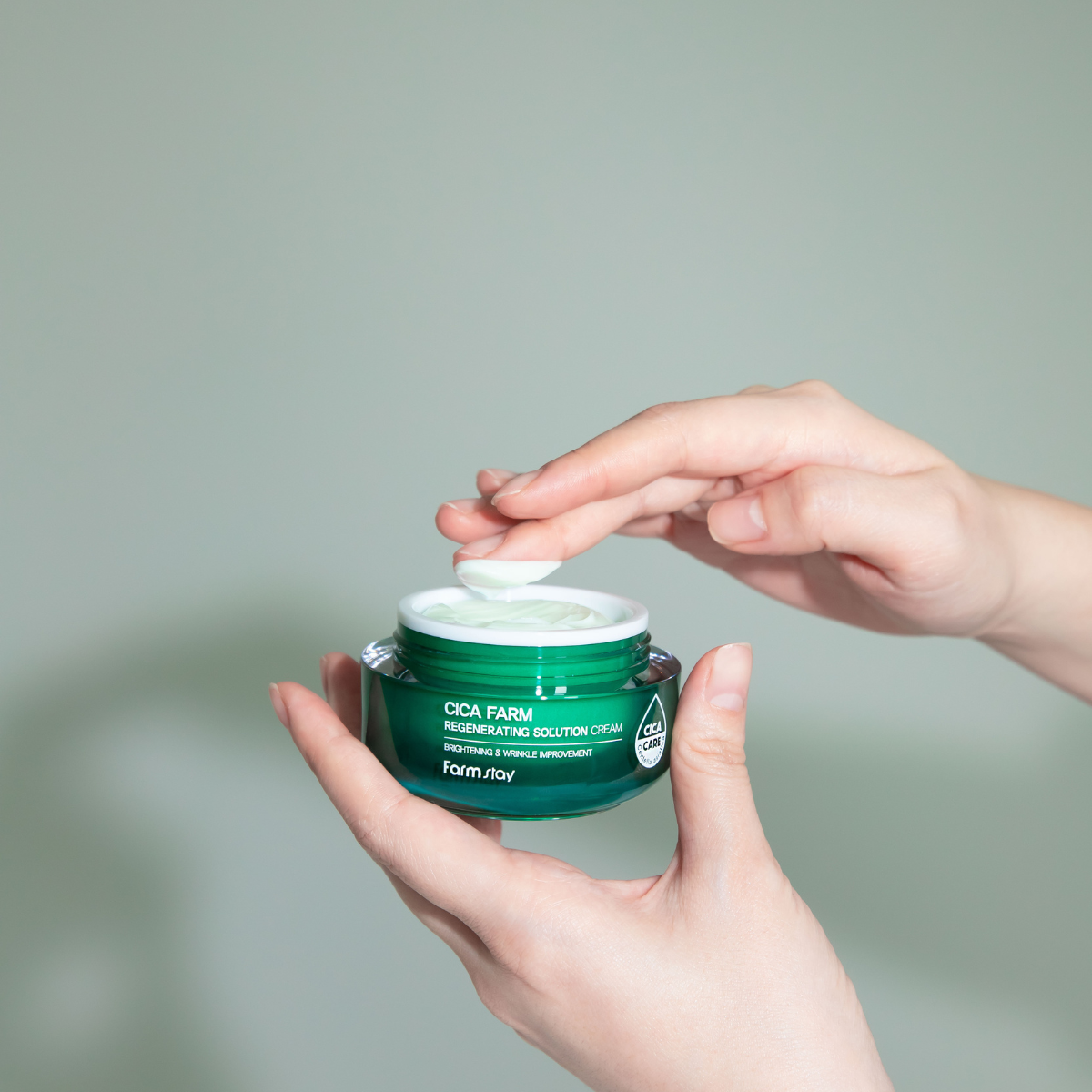 Farmstay Cica Farm Regenerating Solution Cream face moisturizer in 50ml jar with a smooth, soothing cream texture and green packaging.