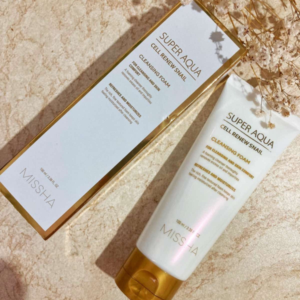 Missha Super Aqua Cell Renew Snail Cleansing Foam in a 100ml tube, showcasing its gel and foam cleanser texture and packaging.