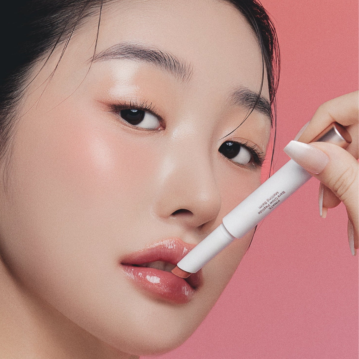 Pinate Bare Glow Peptide Melting Balm lipstick in a sleek, natural finish with smooth, creamy texture and subtle glow.
