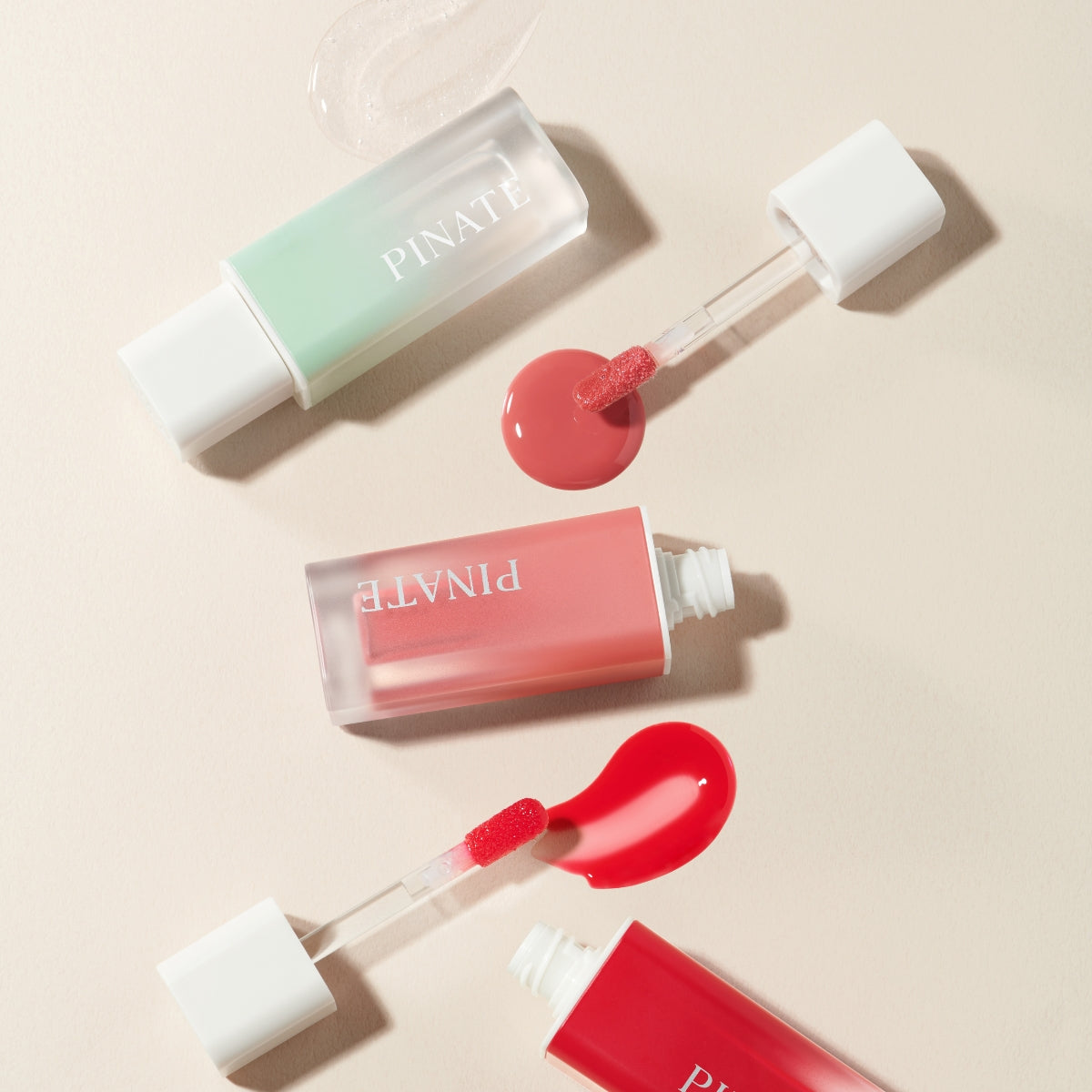 Pinate Natural Bloom Lip Oil Serum in clear lip gloss tube, glossy finish, and smooth applicator visible.