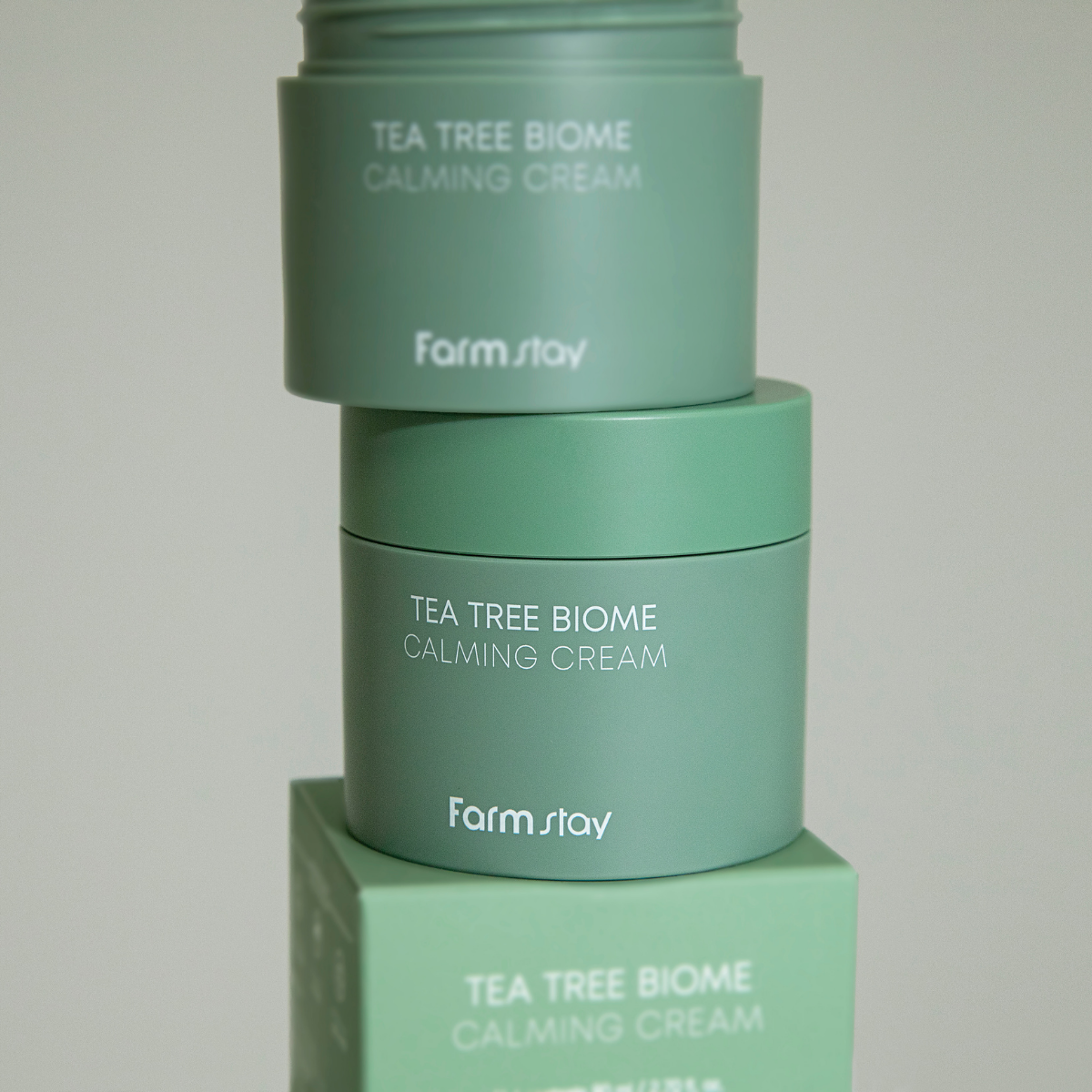 Farmstay Tea Tree Biome Calming Cream 80ml face moisturizer with soothing ingredients and a creamy texture, suitable for calming skin.