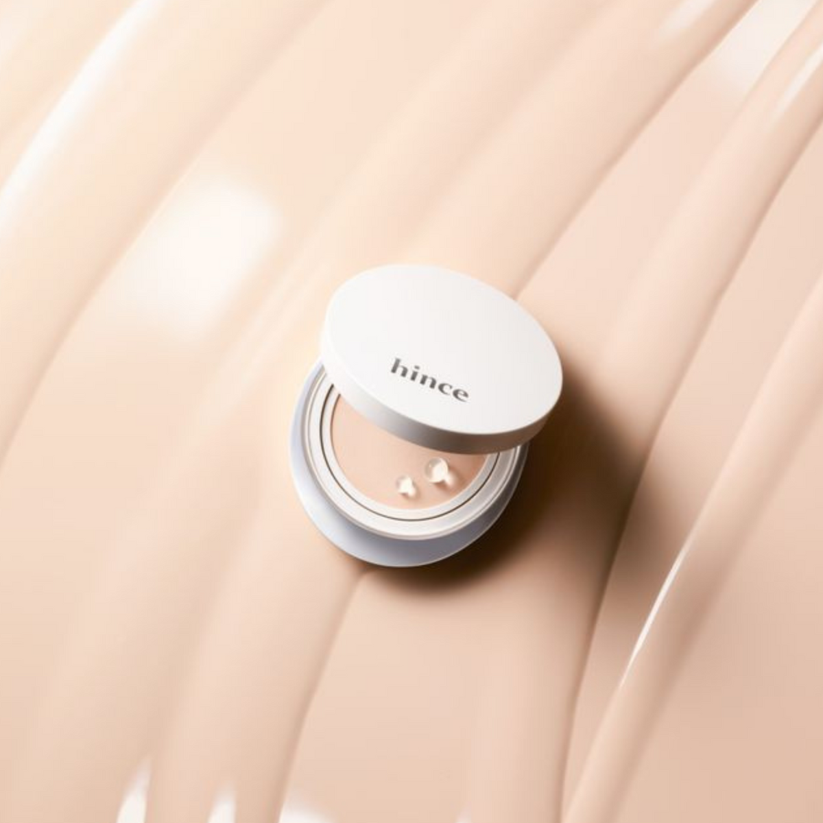 Hince Nu Glow White Cushion foundation in a compact, with a smooth, luminous finish and a soft applicator sponge.