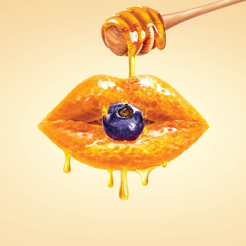 Frudia Blueberry Hydrating Honey Lip Balm in a 10ml tube, featuring a blue and honey-colored packaging for moisturizing lips