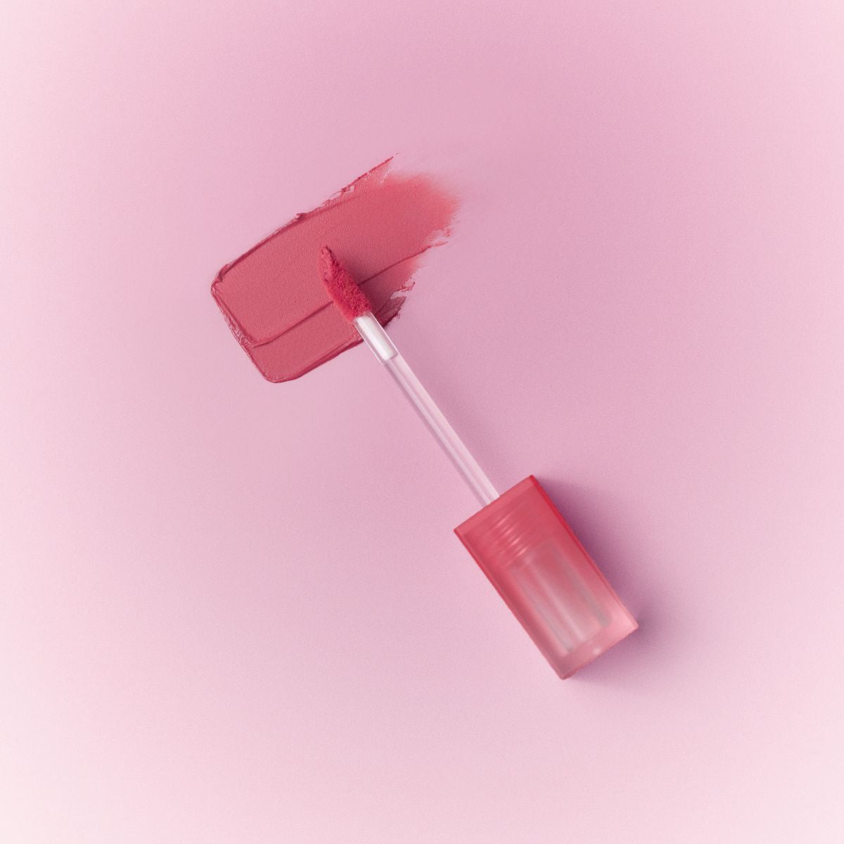Peripera Over Blur Tint lip tint in a soft pink shade, showcasing the smooth applicator and vibrant color on lips.