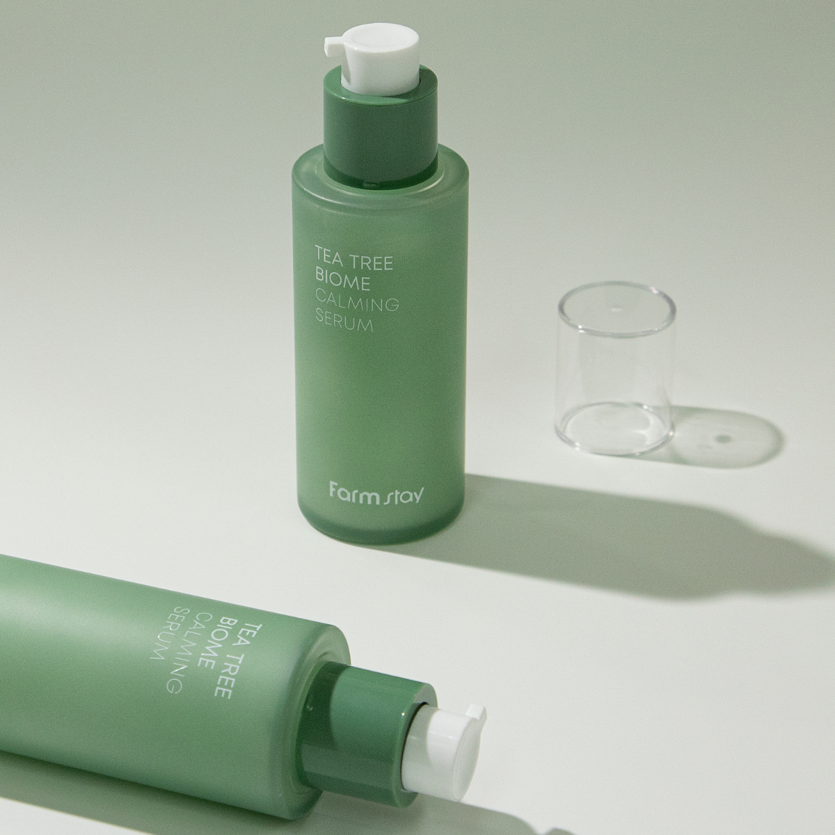 Farmstay Tea Tree Biome Calming Serum 50ml bottle with dropper, featuring clear serum inside, designed for soothing skin.