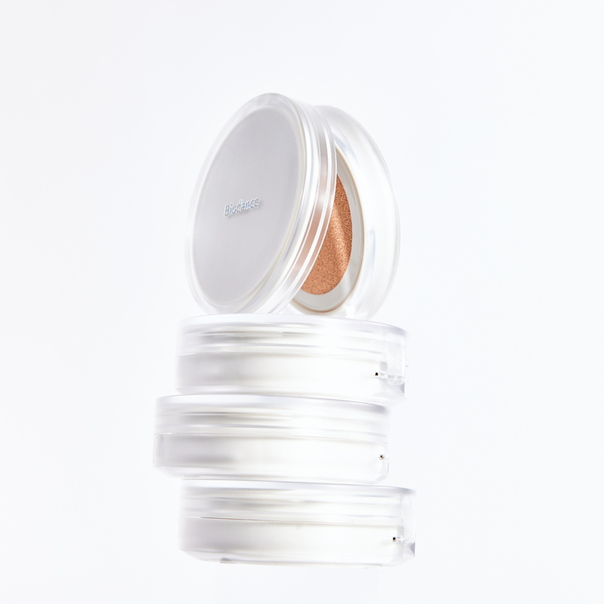 Biodance Radiant Pure Essence Cushion foundation with a compact case and sponge applicator, showcasing a luminous finish.