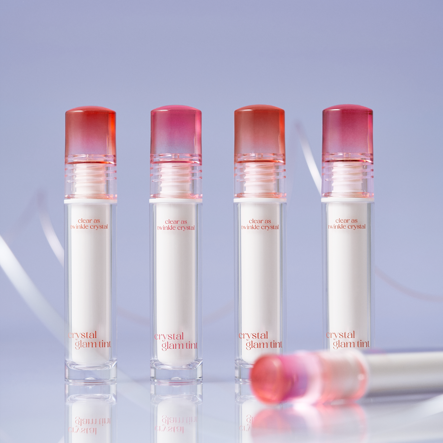 Clio Crystal Glam Tint lip tint in a clear glass bottle with silver cap, showcasing the vibrant pink shade inside.