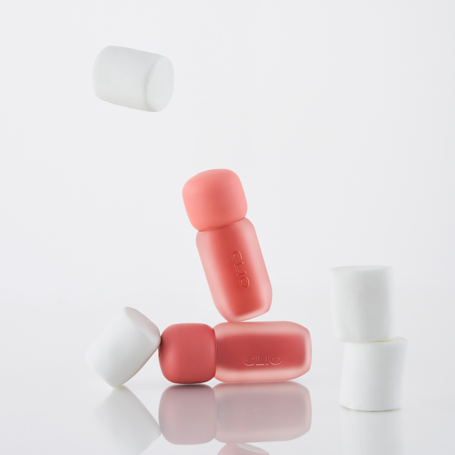 Clio Volumate Blur Tint lip tint in four shades, featuring smooth, glossy finish and vibrant color on lips.