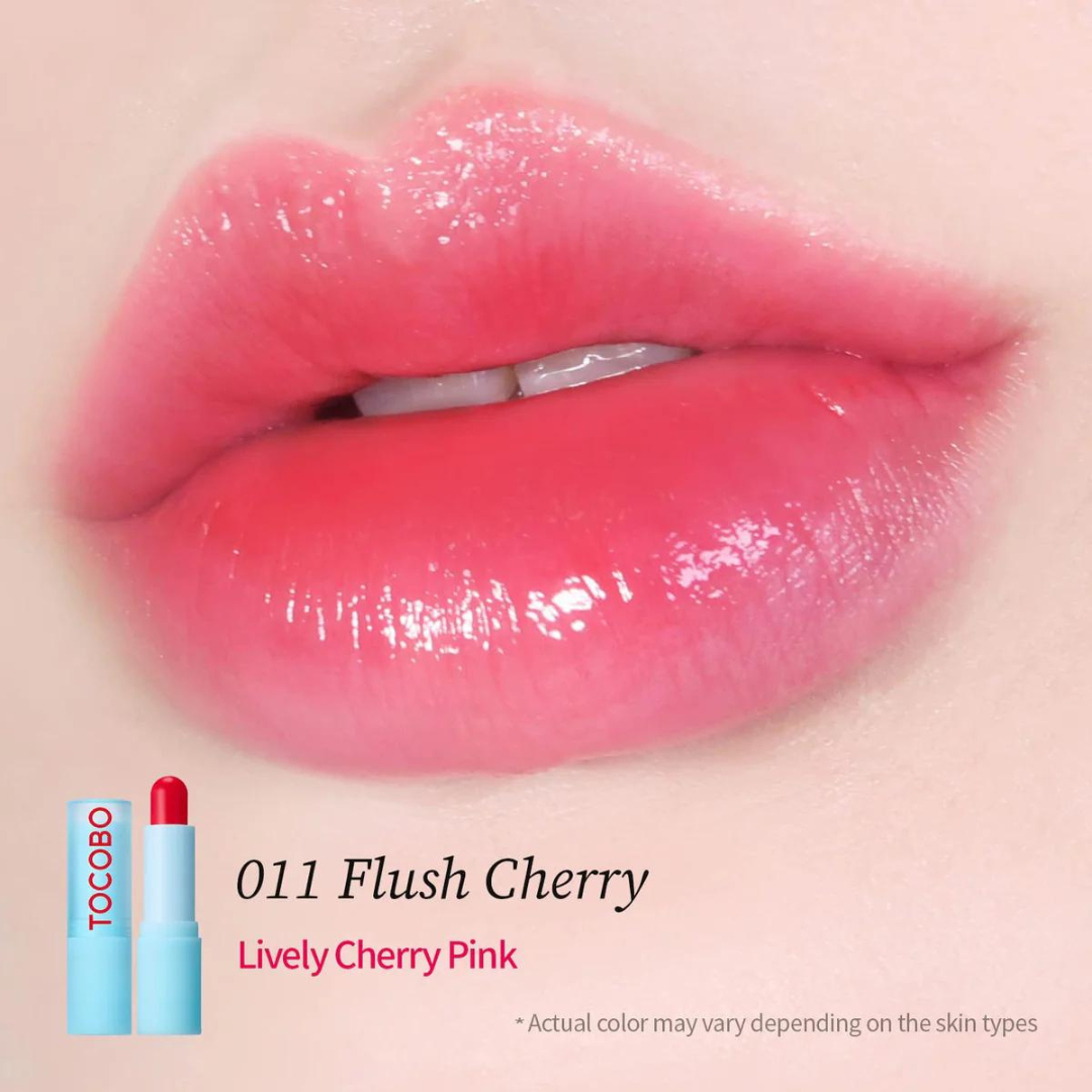 TOCOBO glass tinted lip balm and essence in a clear container, showing a subtle color and glossy finish.