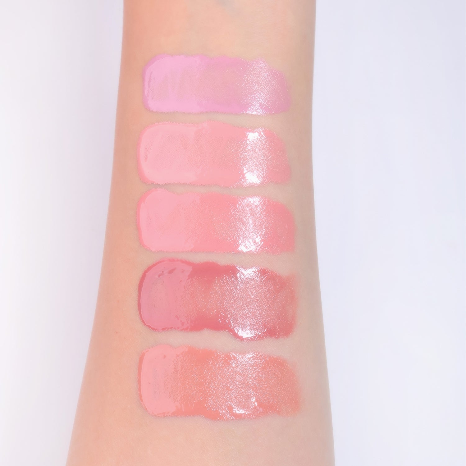 Wakemake Sheer Glow Liquid Blusher in a transparent bottle, showing soft pink shade and applicator tip for luminous cheeks.