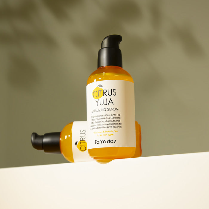 Farmstay Citrus Yuja Vitalizing Serum in a 100ml bottle, showcasing the clear serum with citrus fruit elements.