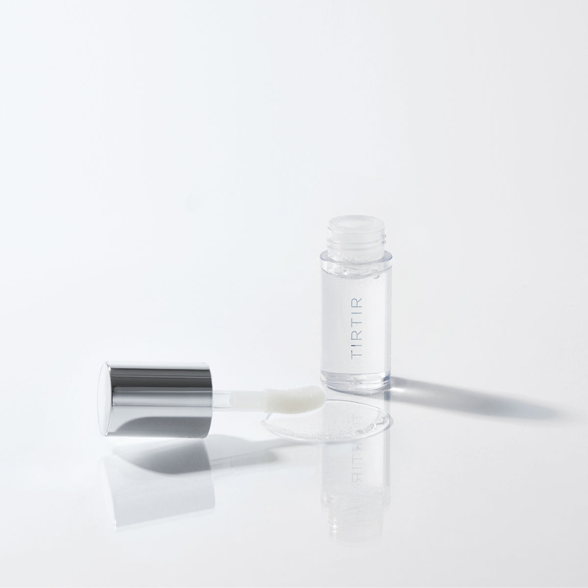 TIRTIR My Glow Lip Oil Honey in 5.7ml, a clear lip gloss with a nourishing honey formula, shown in a sleek tube.