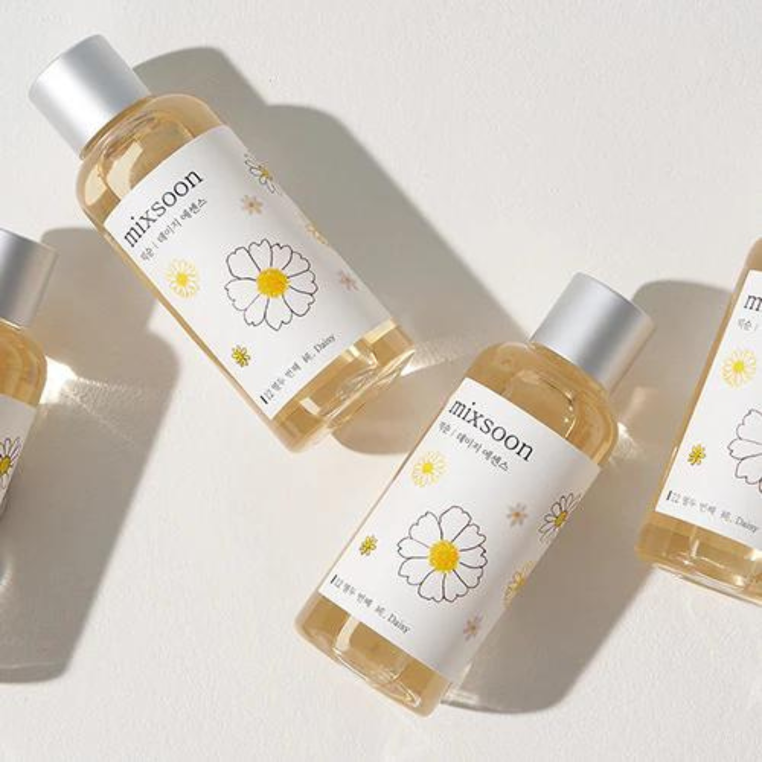 Bottle of Mixsoon Daisy Essence 100ml, clear glass container with white label, showcasing the floral essence product.