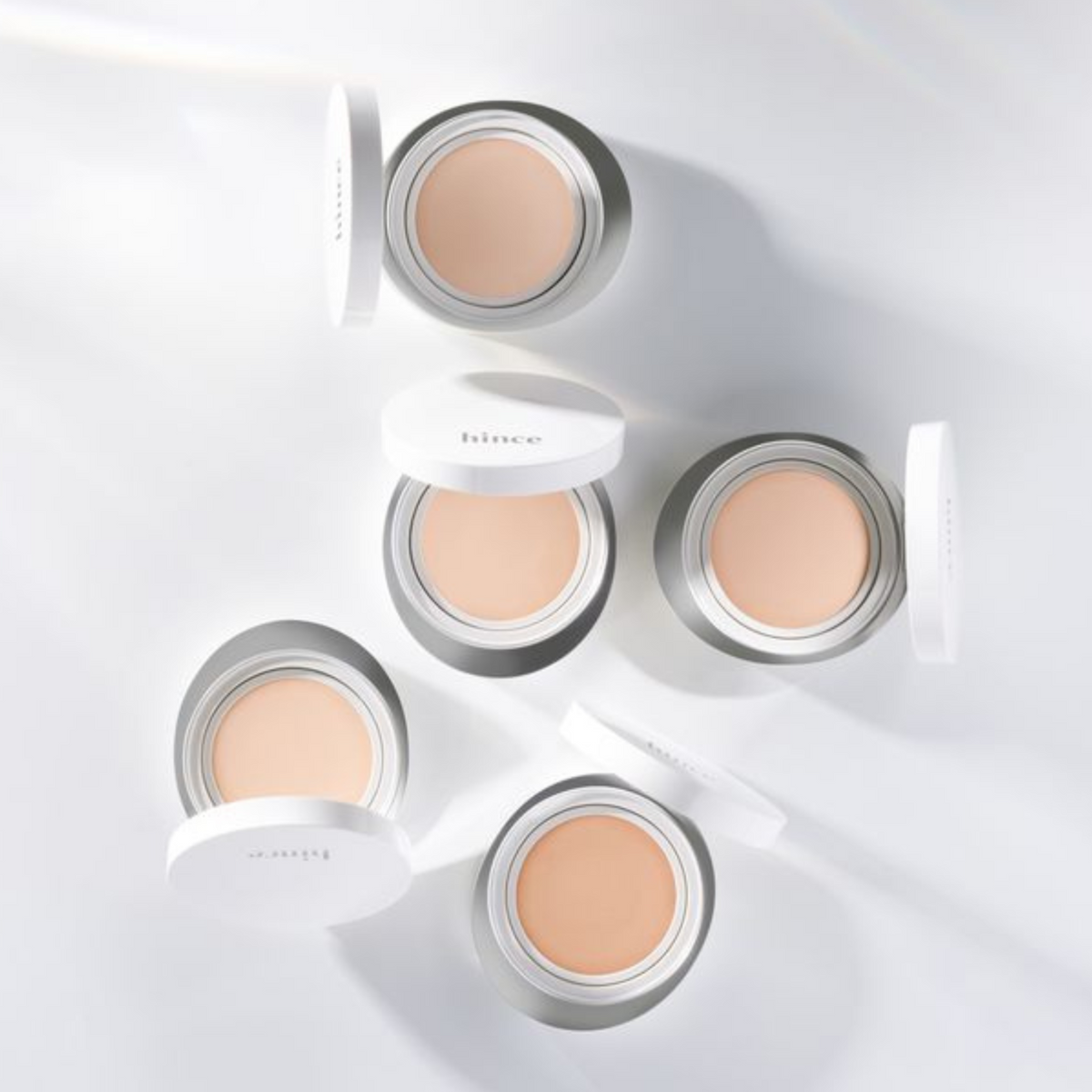 Hince Nu Glow White Cushion foundation in a compact with a mirror, showcasing its smooth, luminous finish and sleek packaging.