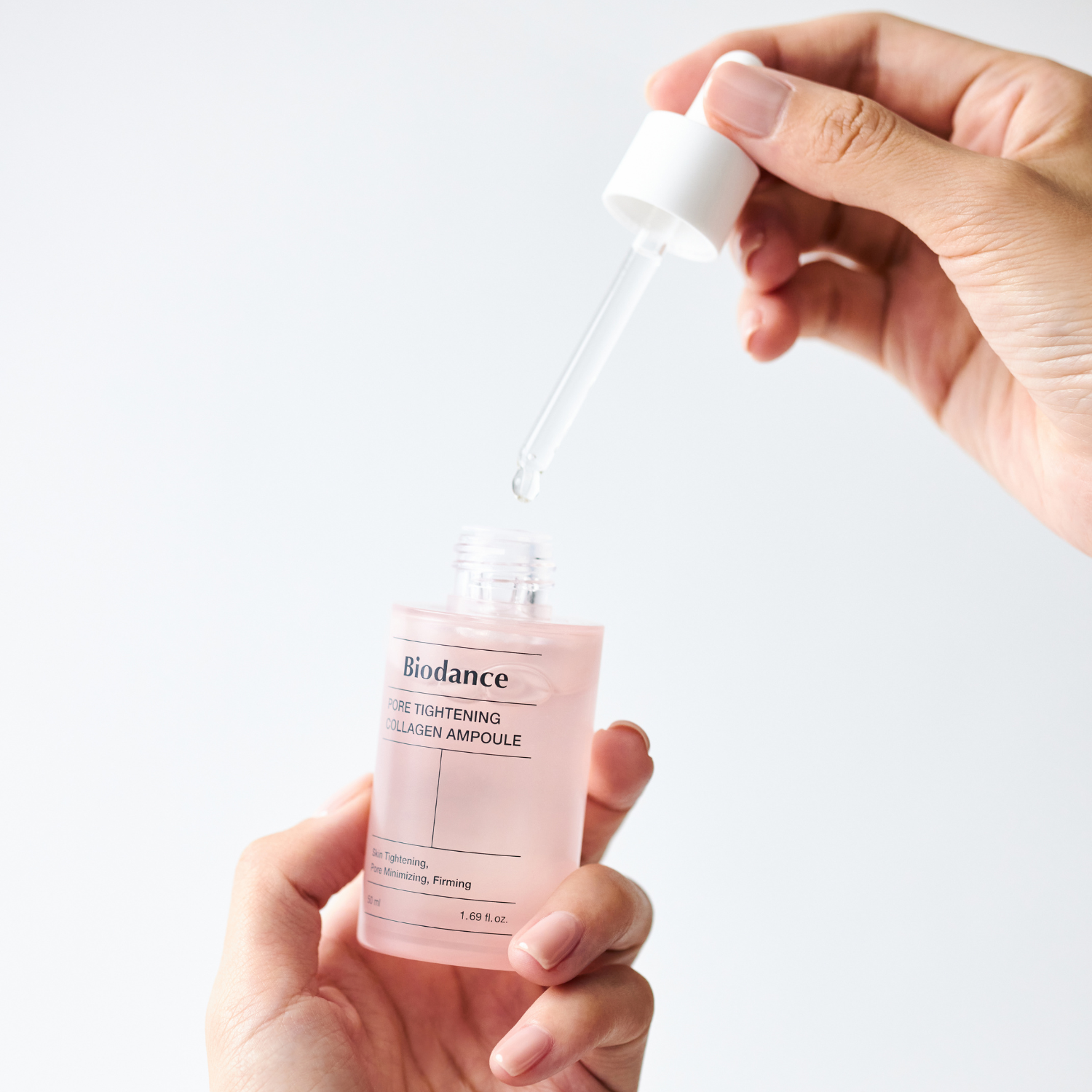 Biodance pore tightening collagen ampoule in a clear 50ml bottle, with a dropper cap and liquid inside.