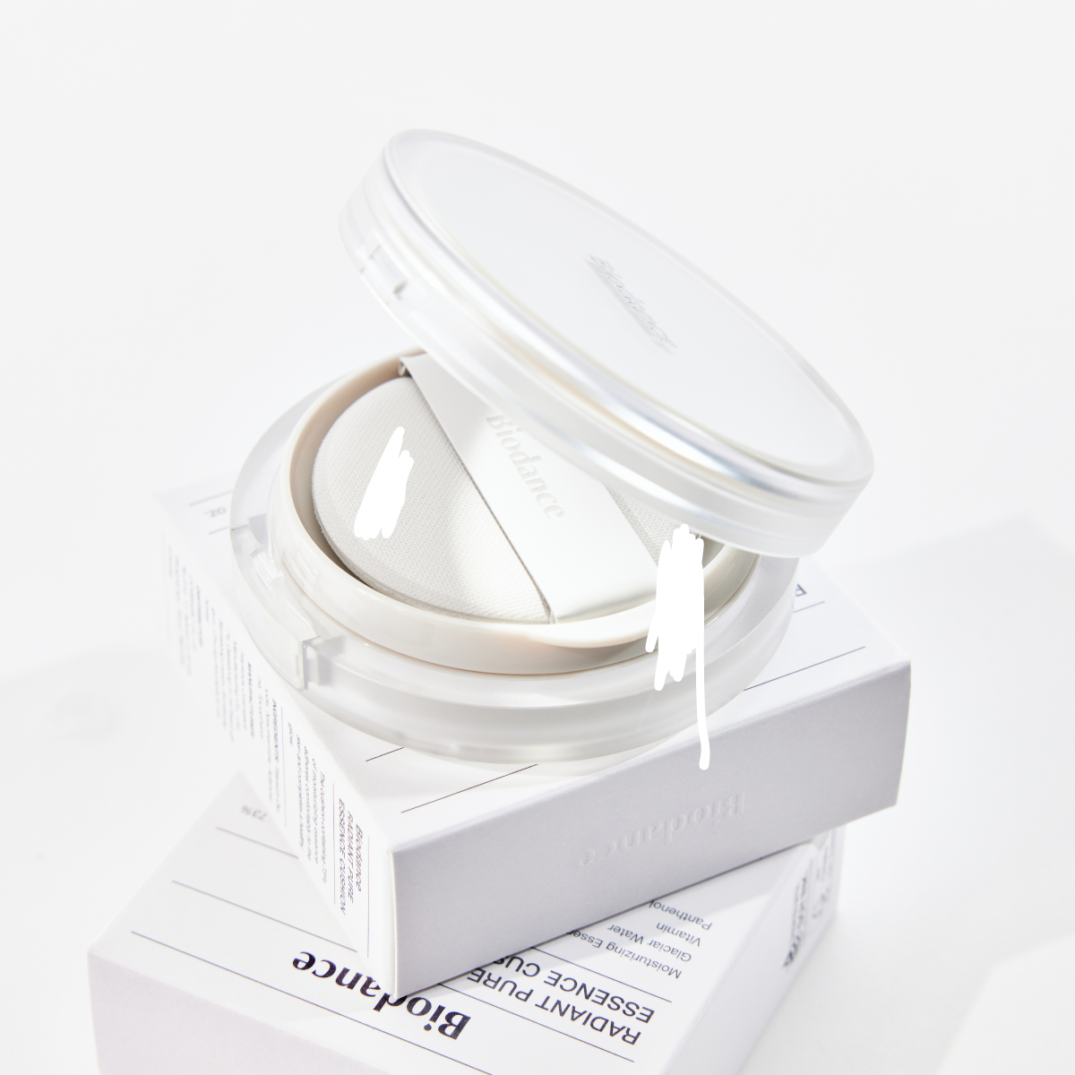 Biodance Radiant Pure Essence Cushion foundation in a compact with a sponge applicator, showcasing smooth, luminous skin finish.
