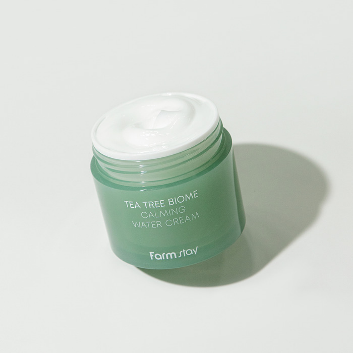 Farmstay Tea Tree Biome Calming Water Cream face moisturizer in 80ml jar, showing the product packaging and label.