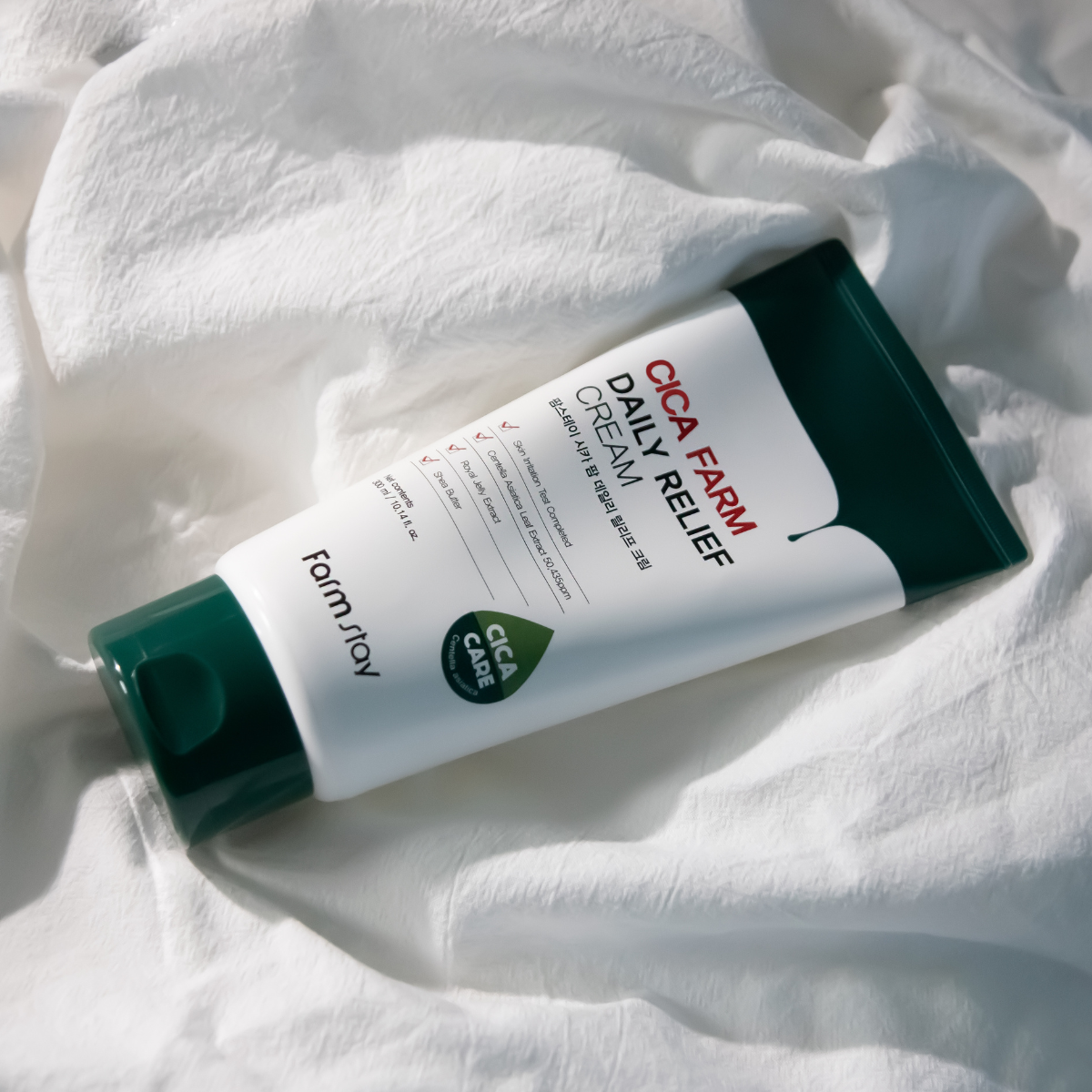 Farmstay Cica Farm Daily Relief Cream face moisturizer in a 300ml jar, showing smooth, soothing cream texture.