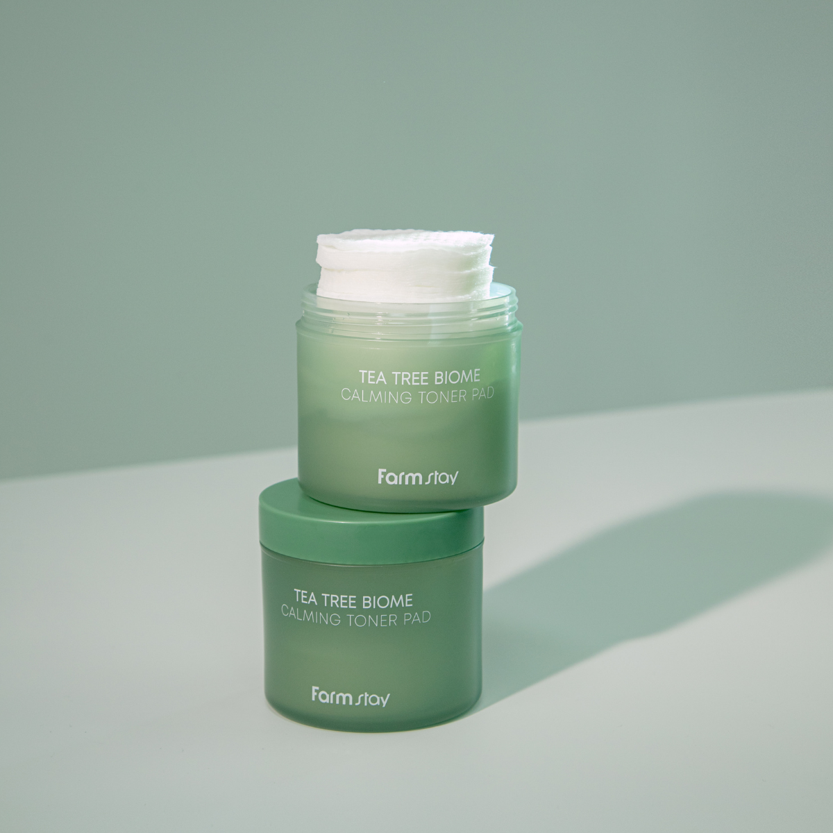 Farmstay Tea Tree Biome Calming Toner Pad 140ml with soothing ingredients and soft cotton pad for gentle skin toning and refreshment.