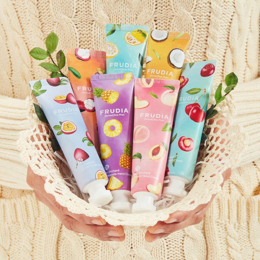 Frudia My Orchard Hand Cream tube with natural ingredients, showcasing a soft, nourishing formula for smooth hands.