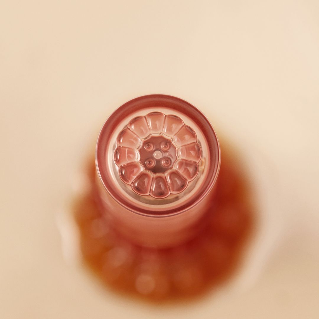 Peripera Ink Mood Glowy Tint Honey K-ookie lip tint in a clear glass tube with a doe-foot applicator, showcasing warm honey shade.