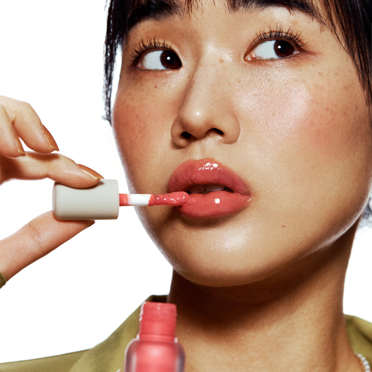 Unleashia Sisua Popcorn Syrup Lip Plumper with glossy finish, highlighting plumper lips and smooth texture in a close-up shot.