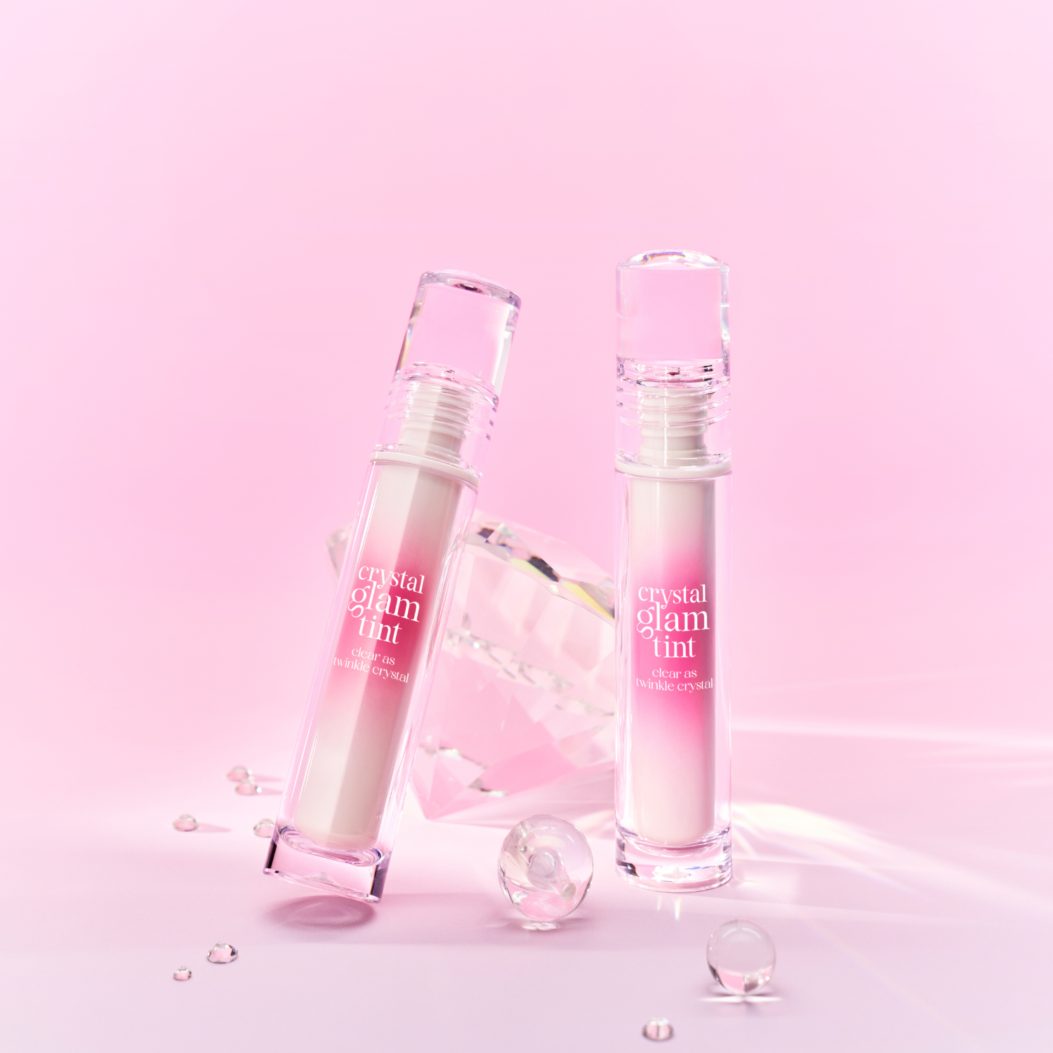 Clio Crystal Glam Tint luxury lip tint in a sleek tube, featuring a shimmering, translucent pink color for a glossy lip look.