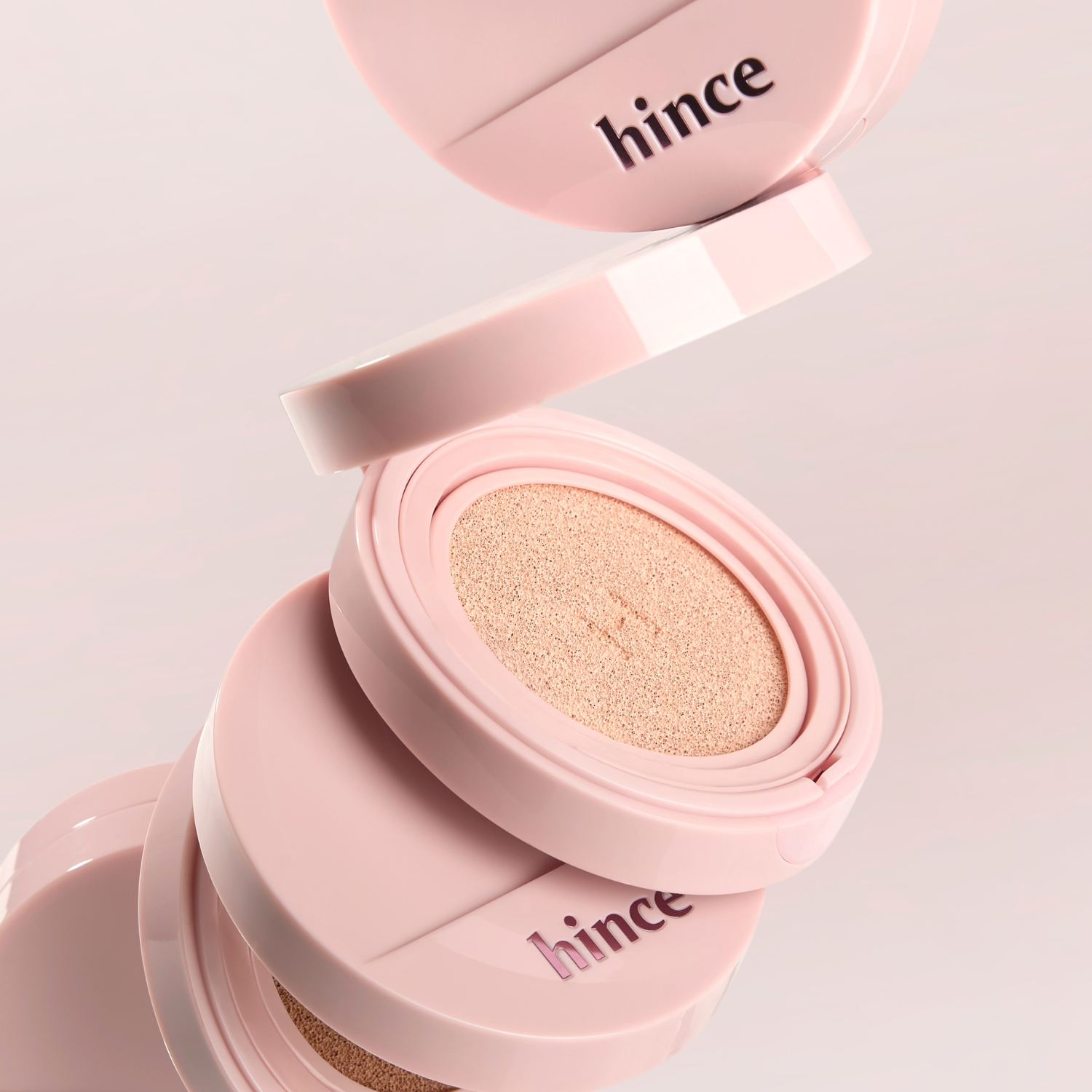 Hince Cover Master Pink Cushion foundation in a compact with pink packaging and applicator sponge.