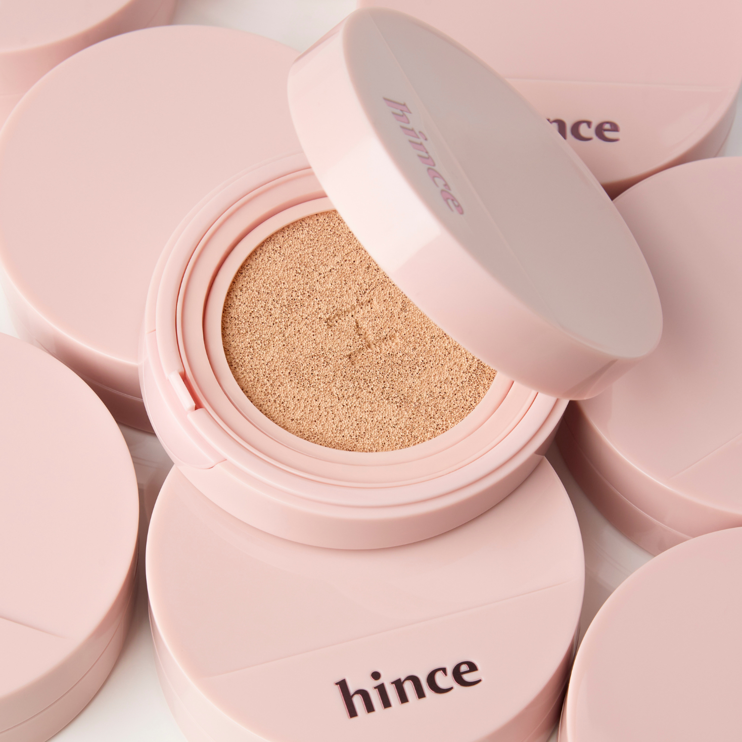 Hince Cover Master Pink Cushion foundation in a compact with a pink cover, showcasing its smooth, ready-to-apply surface.