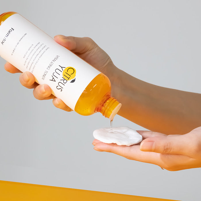 Farmstay Citrus Yuja Vitalizing Toner in a 280ml bottle, showing the clear liquid and citrus-themed packaging.