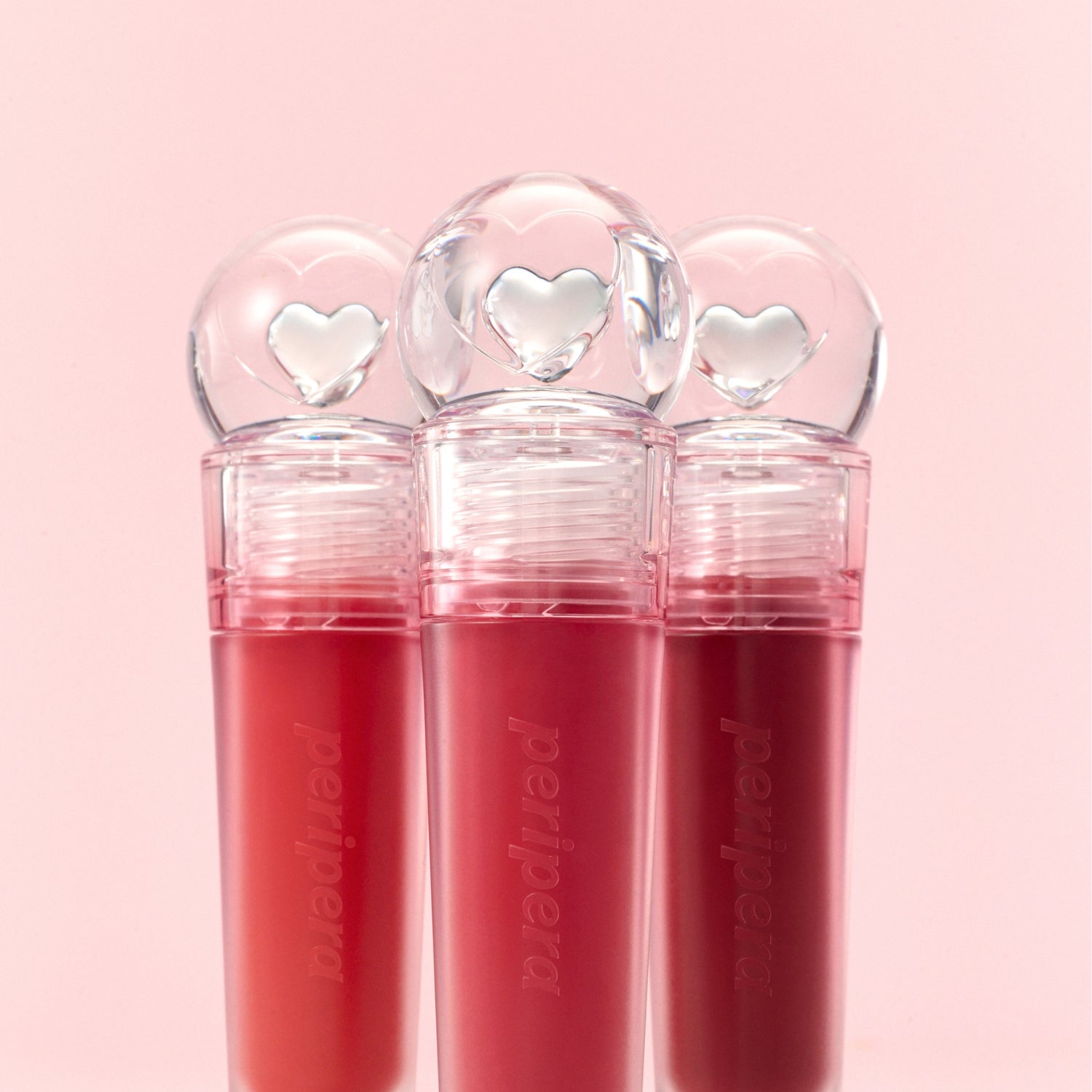 Peripera Ink Jellable Lip Tint in vibrant shade, showcasing its glossy, gel-like texture on lips.