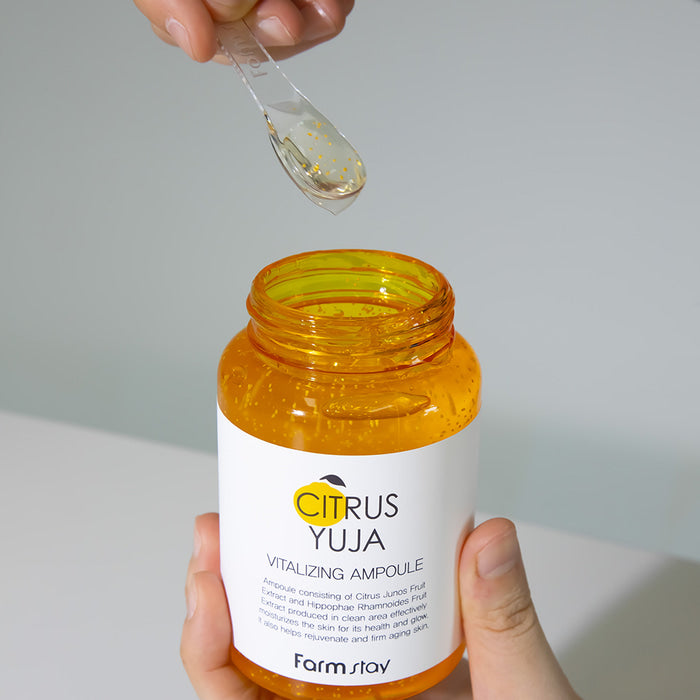 Farmstay Citrus Yuja Vitalizing Ampoule 250ml bottle, showcasing the bright, citrus-infused skincare product with a pump dispenser.