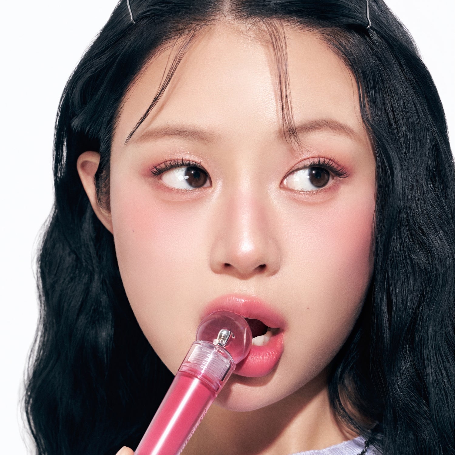 Peripera Ink Jellable Lip Tint in a vibrant pink shade, showcasing the glossy, gel-like texture on the lips.