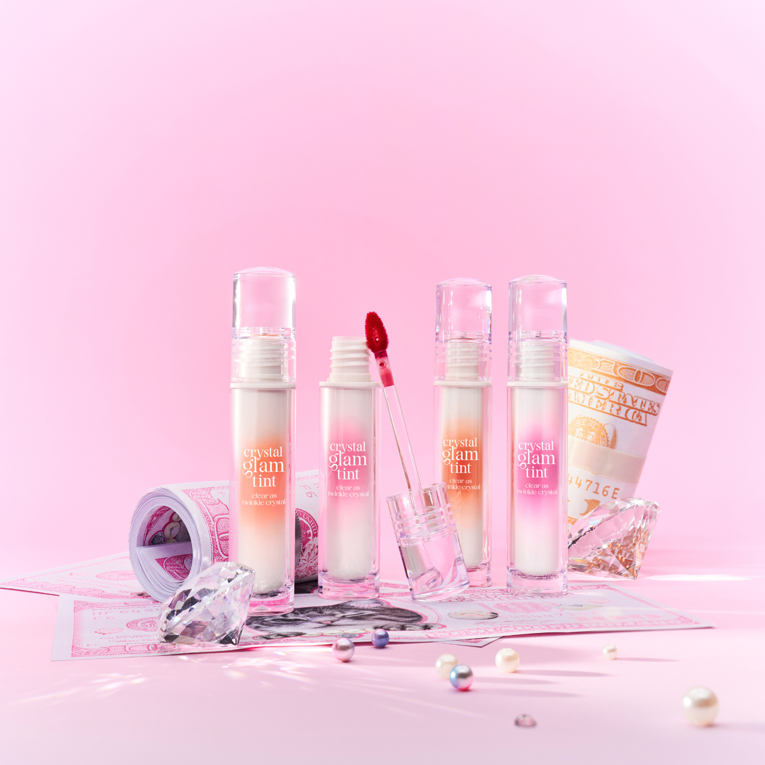 Clio Crystal Glam Tint luxury lip tint in a sleek tube, showcasing a vibrant, shimmering color perfect for a glossy finish.