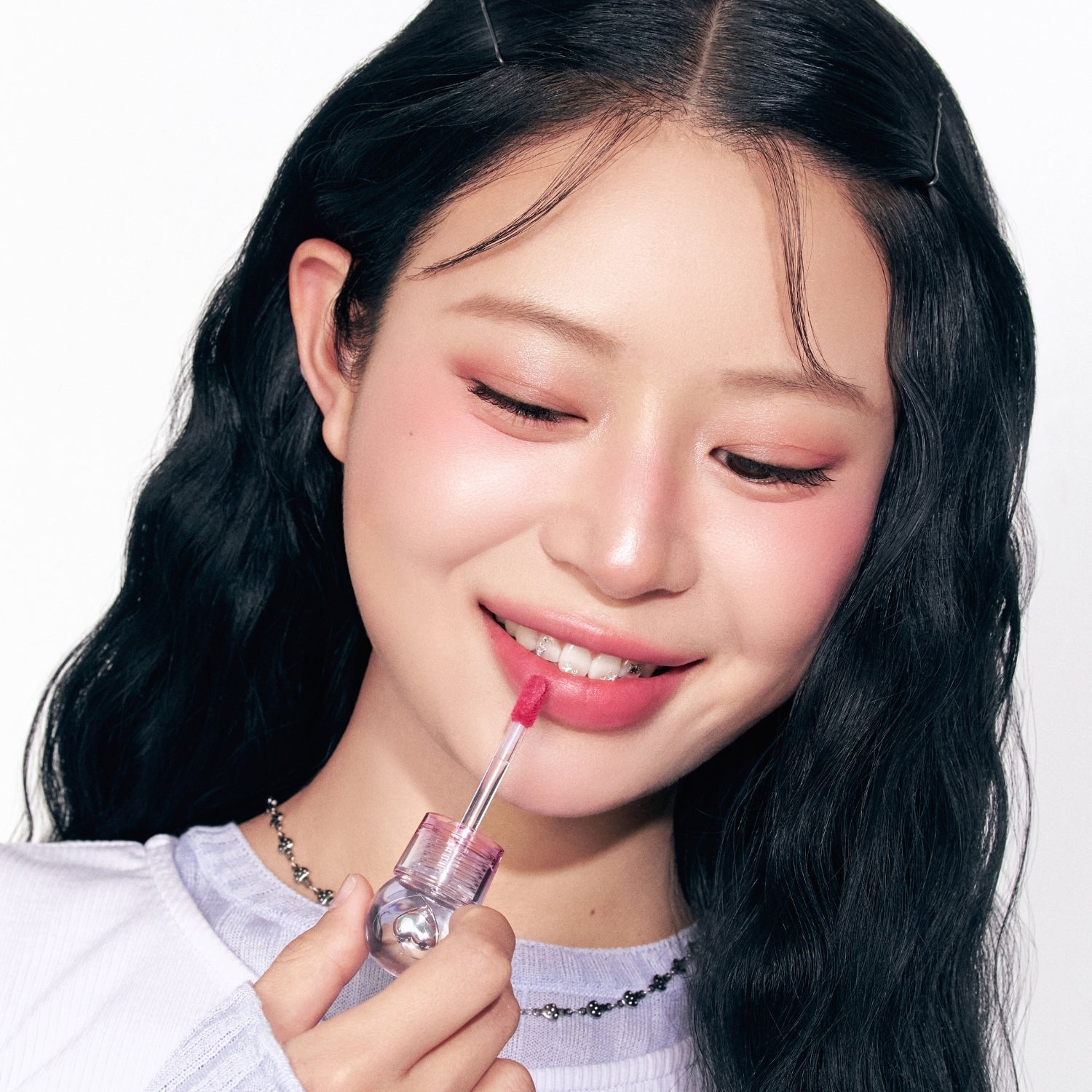Peripera Ink Jellable Lip Tint in soft pink, showcasing the smooth, glossy texture and applicator brush on the product.