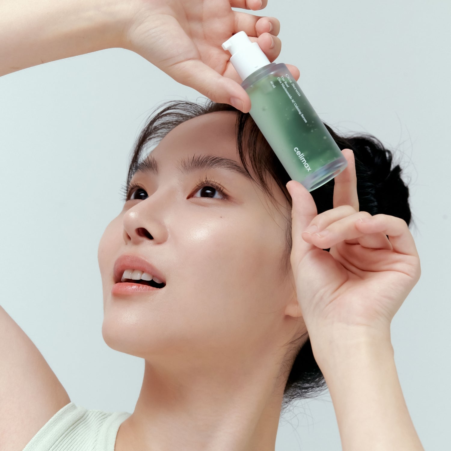 Celimax The Real Cica Niacinamide AC Calming Serum in 40ml being applied to face and throat for soothing skincare.