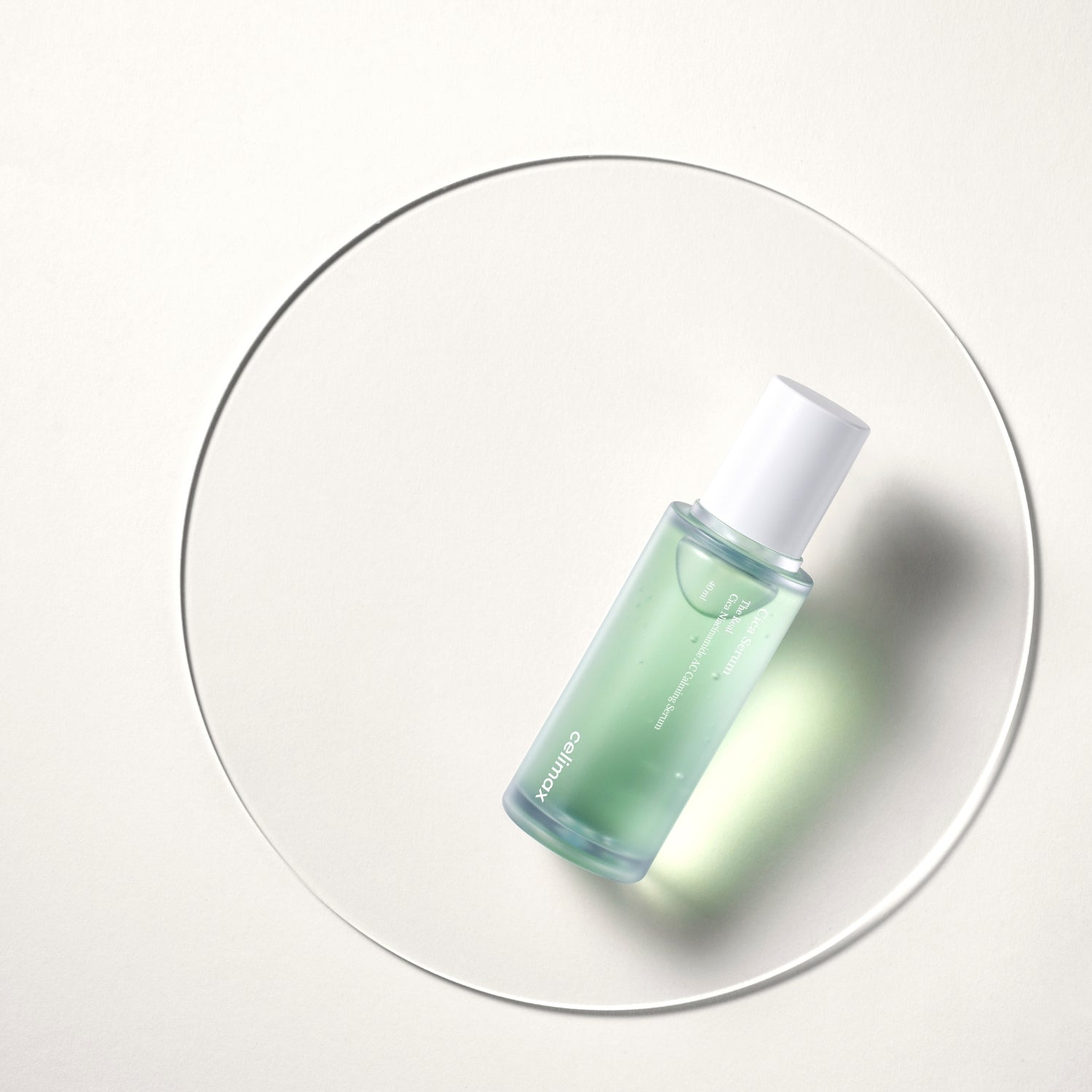 Celimax The Real Cica Niacinamide AC Calming Serum 40ml being applied to face and throat before ginseng cream in skincare routine.