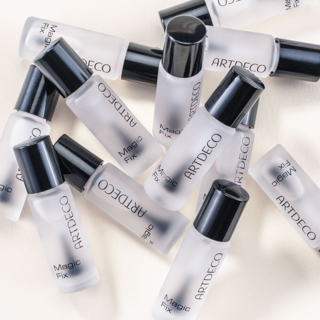 ARTDECO Magic Fix lip gloss packaging showing sleek tube and applicator with shiny, clear finish.